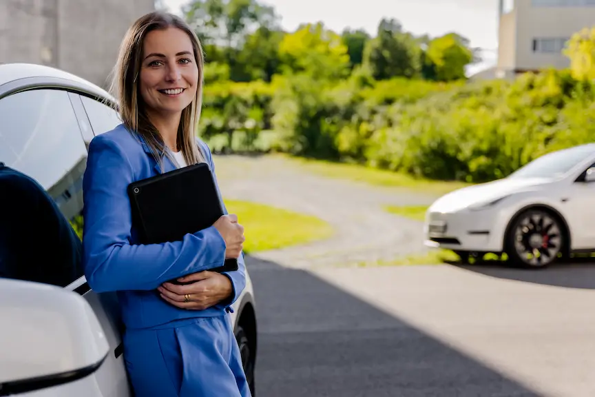 Woman stands near a car