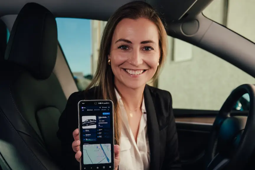 Woman in a car shows Fleets app